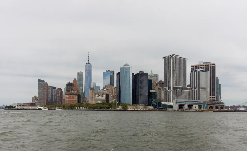 Lower Manhattan office towers seen across the water on an overcast day