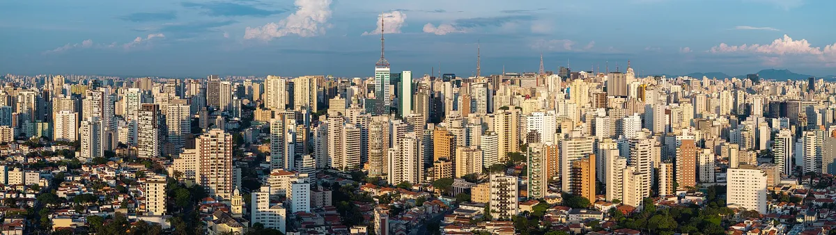 Aerial view of dense high-rise apartment buildings across São Paulo under a cloudy sky
